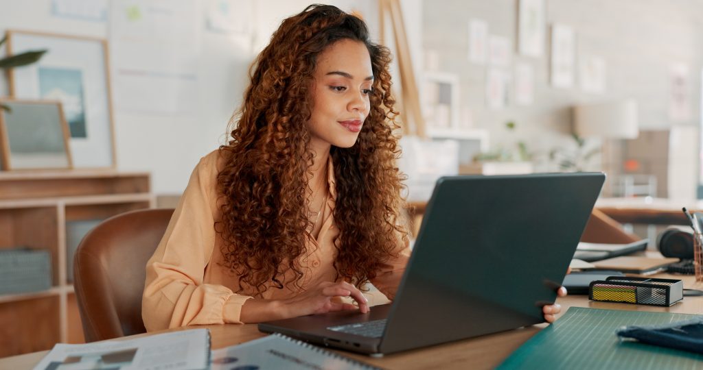 Black woman documents or working on laptop planning creative research or data analysis for marketing project management review Business typing corporate report schedule or SEO calendar agenda | Quest Mindshare Researcher screening and verifying new panelists as part of panel recruitment